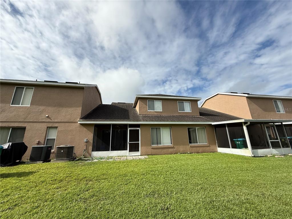 Undisclosed Address Orlando, FL 32824 - Photo 5 of 5 a front view of a house with a yard