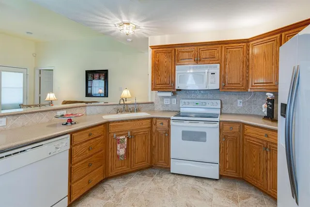 a view of a chair and table in backyard of the house