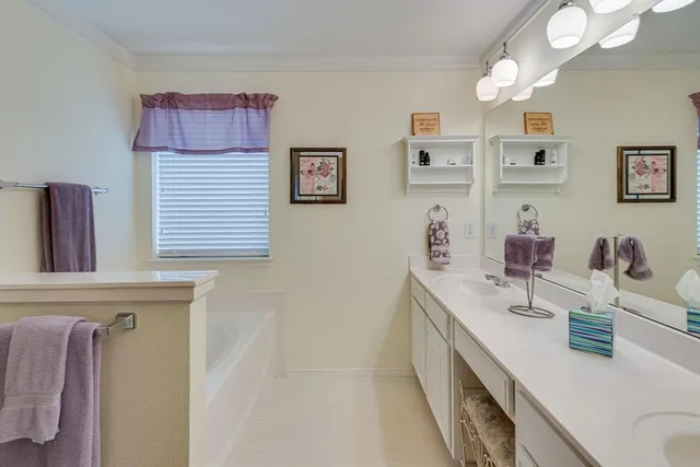 a bathroom with a sink vanity and mirror