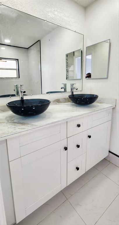 7118 Jenner Avenue New Port Richey, FL 34655 - Photo 5 of 12 a bathroom with a sink and a mirror