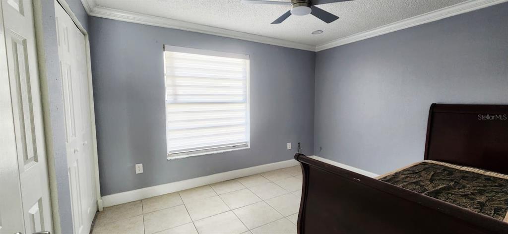 7118 Jenner Avenue New Port Richey, FL 34655 - Photo 8 of 12 a view of room with window and ceiling fan