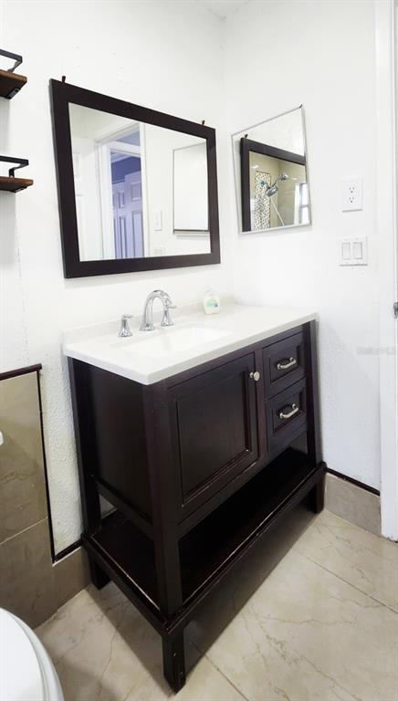 7118 Jenner Avenue New Port Richey, FL 34655 - Photo 9 of 12 a bathroom with a sink and a mirror