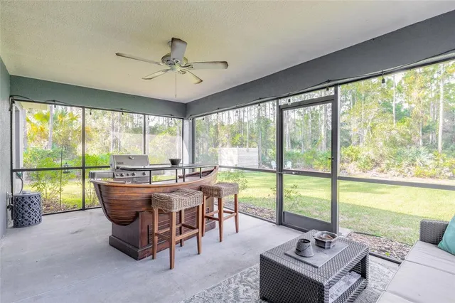 a living room with fireplace furniture and a large window