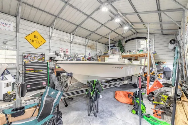 a room with stainless steel appliances kitchen island granite countertop furniture and a sink