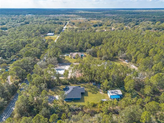 an aerial view of residential house with outdoor space