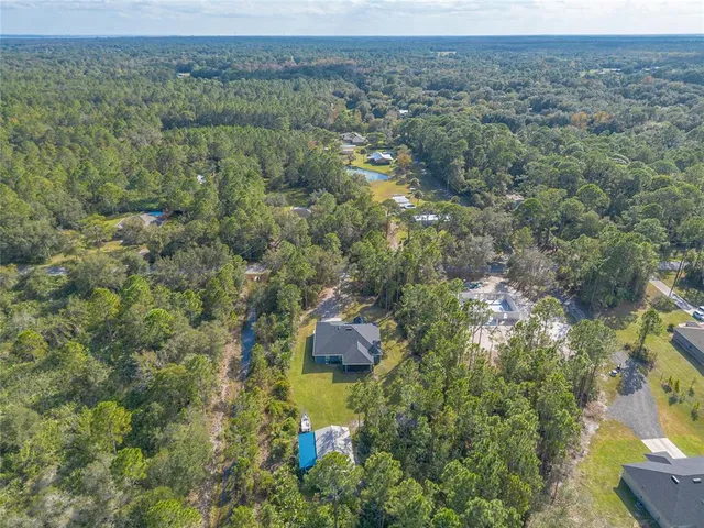 a view of a house with a yard and street