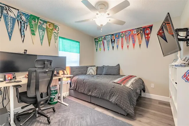 a bedroom with a bed and a desk