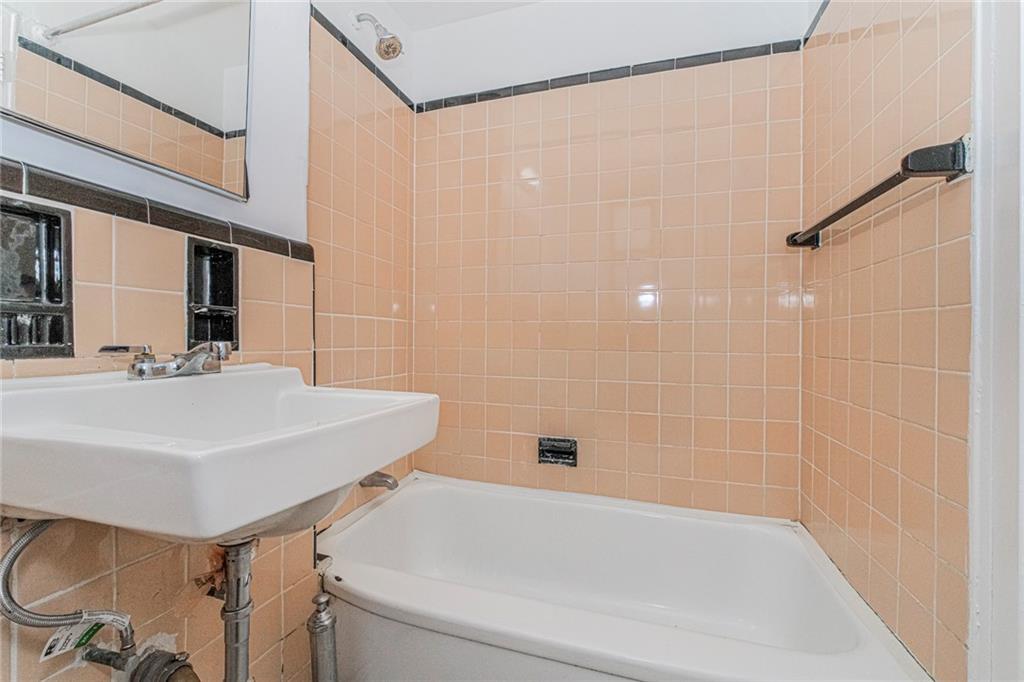 20 89th Street, Unit 3A Brooklyn, NY 11209 - Photo 10 of 18 a bathroom with a sink a toilet and shower