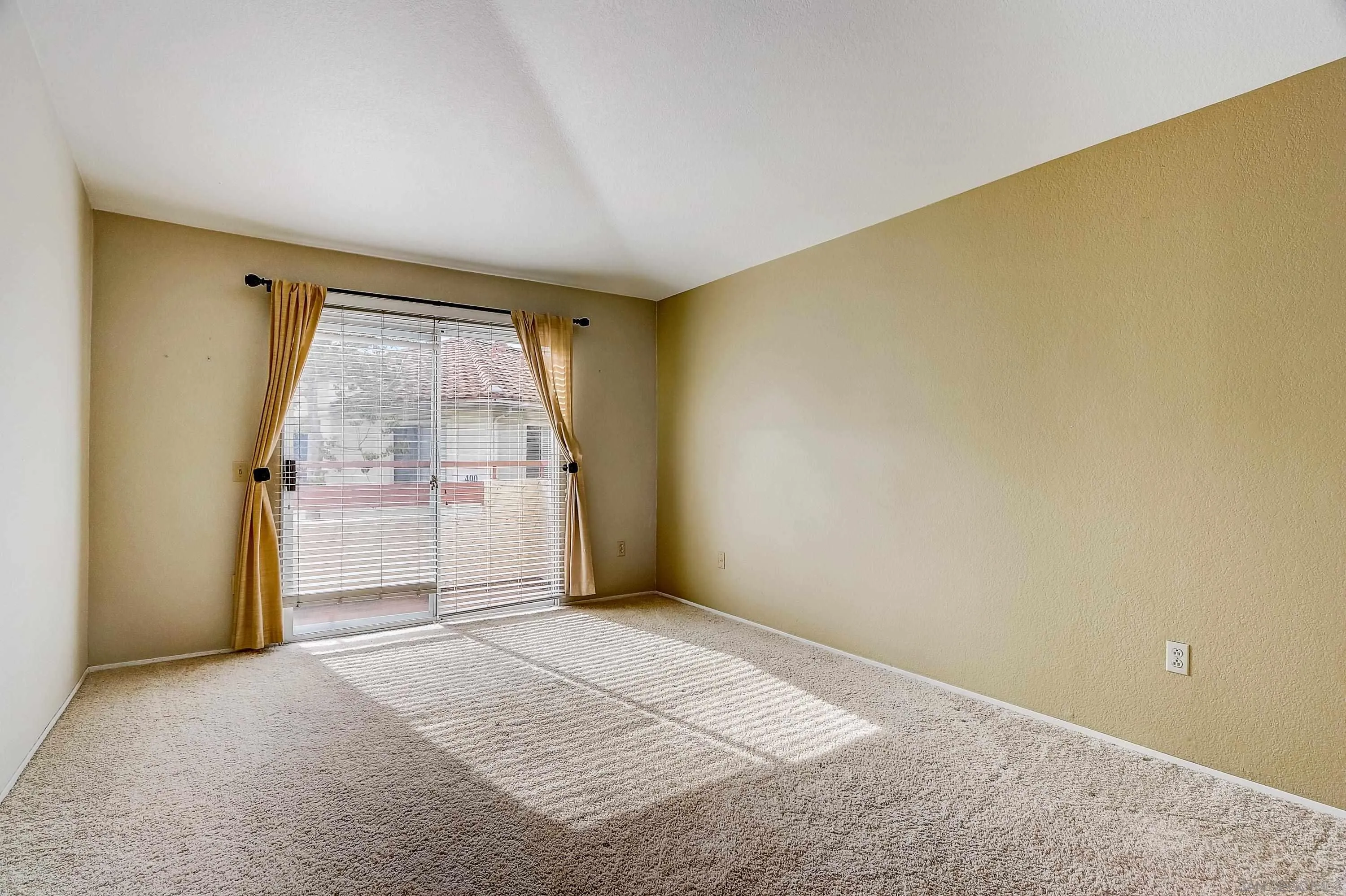 405 Ribbon Beach Way, Unit 249 Oceanside, CA 92058 - Photo 14 of 34 an empty room with a empty space and windows