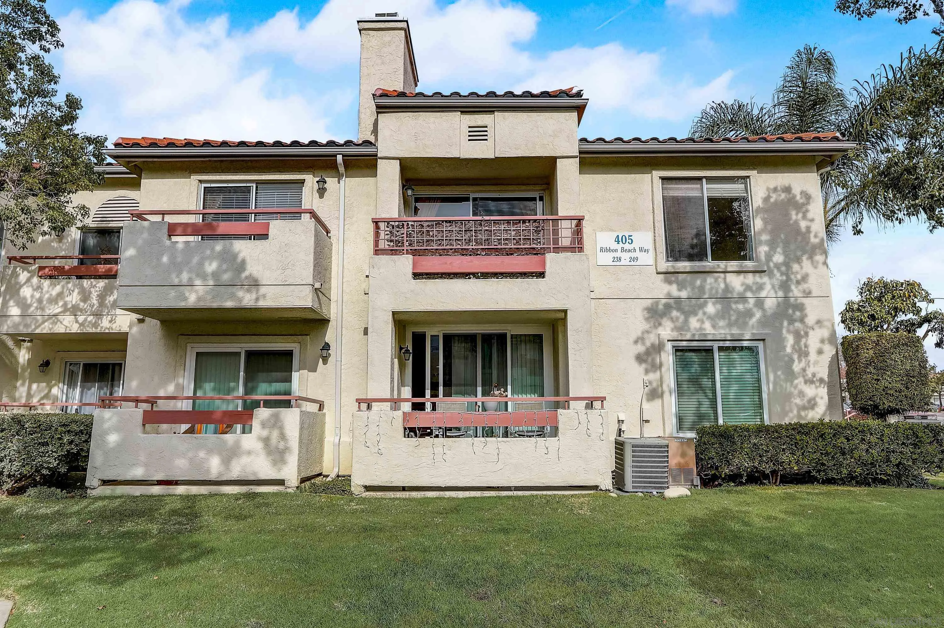 405 Ribbon Beach Way, Unit 249 Oceanside, CA 92058 - Photo 22 of 34 a front view of a house with a yard