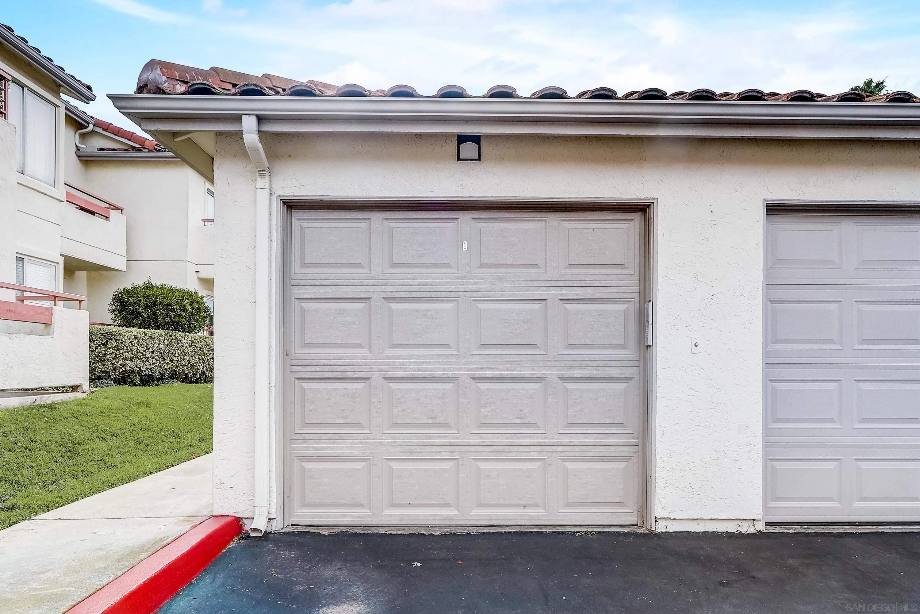 405 Ribbon Beach Way, Unit 249 Oceanside, CA 92058 - Photo 25 of 34 a front view of a house with a yard and garage tub