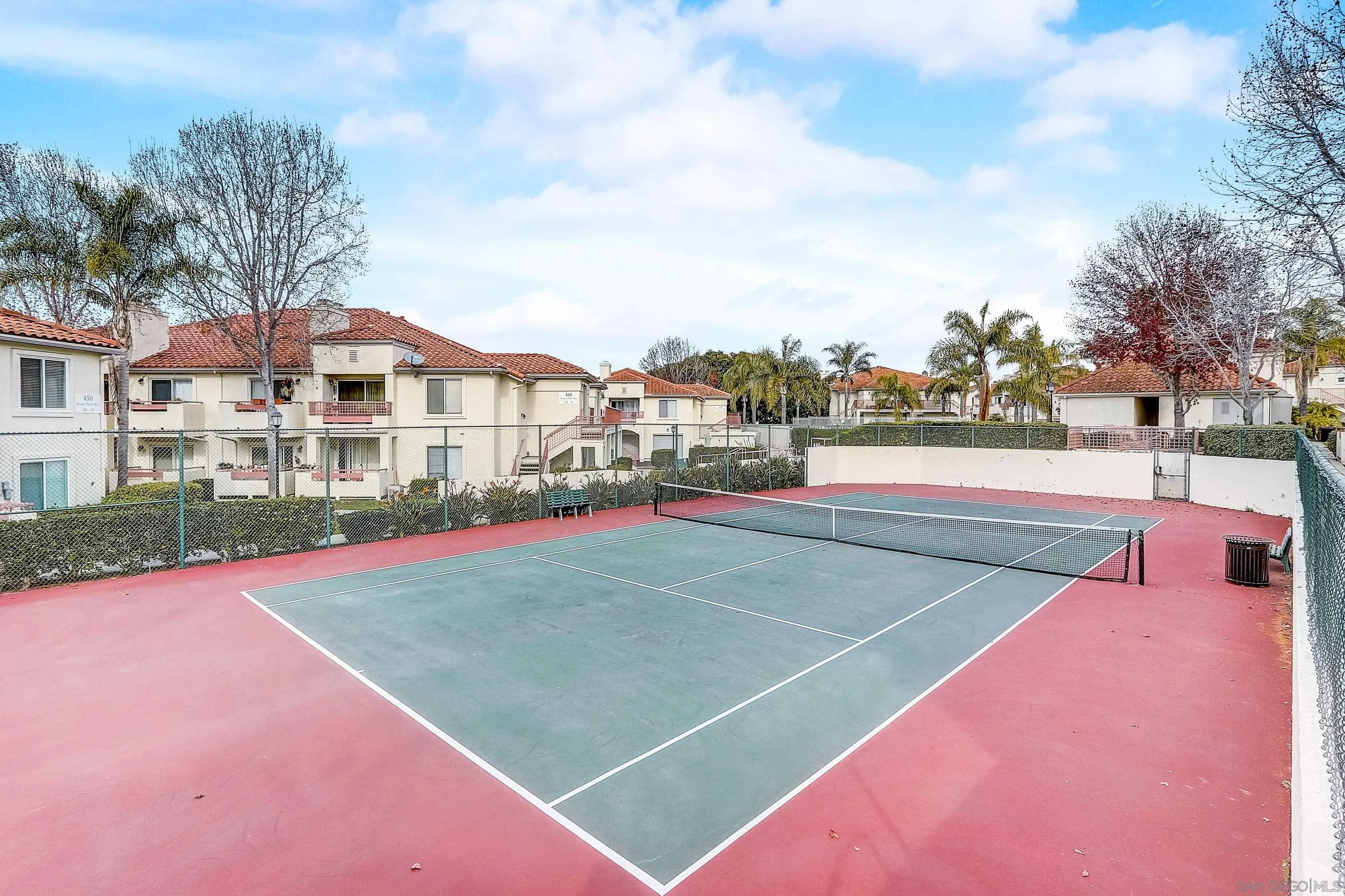405 Ribbon Beach Way, Unit 249 Oceanside, CA 92058 - Photo 31 of 34 a view of a tennis ground with large trees