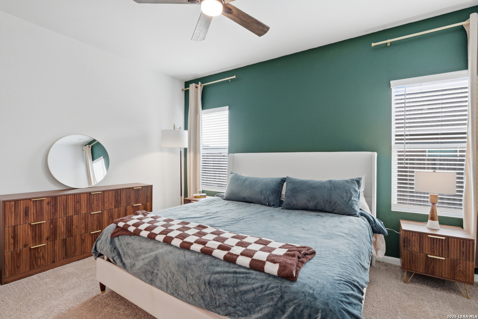 14919 Rhyolite Way Elmendorf, TX 78112 - Photo 12 of 26 a bedroom with a large bed and a window