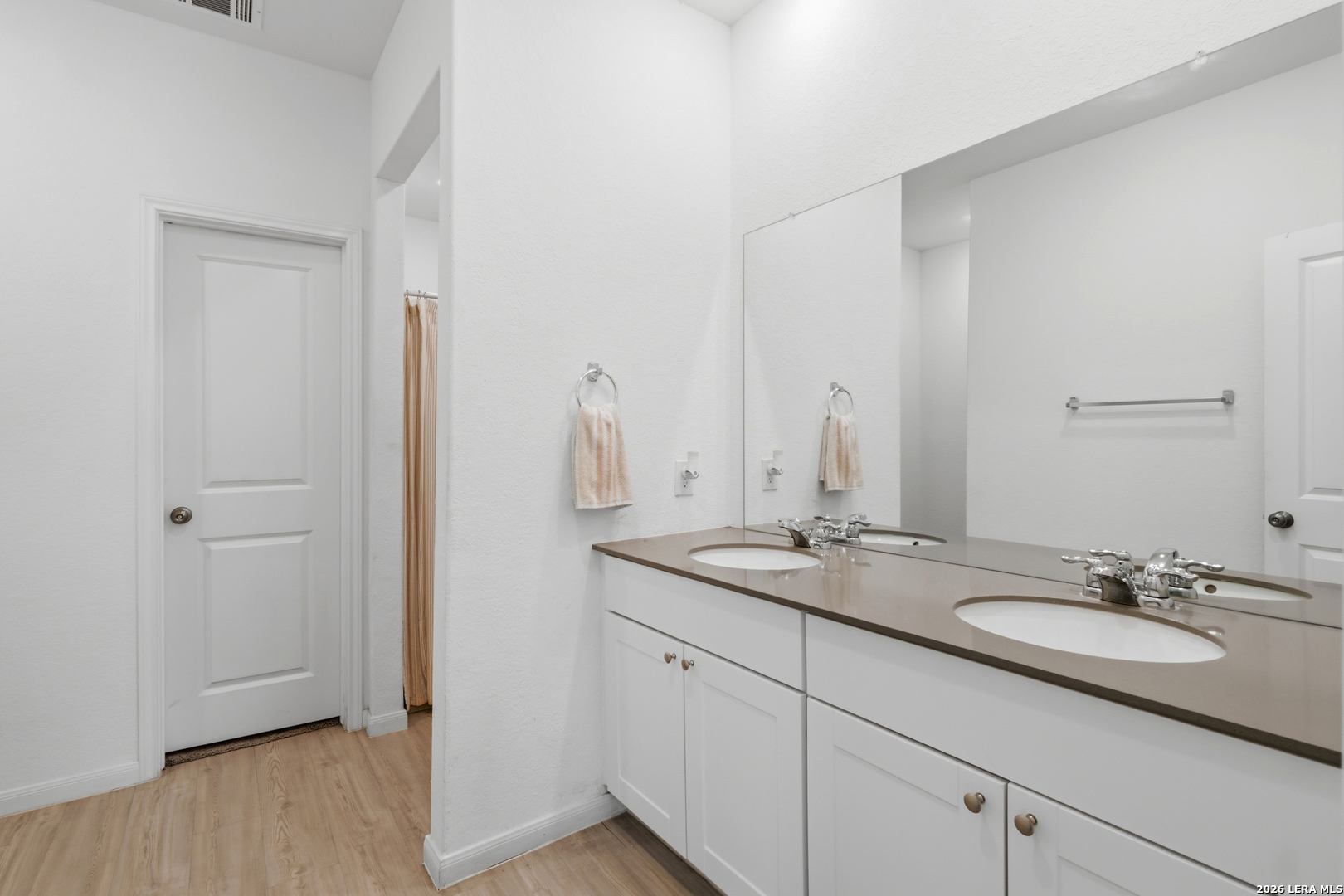 14919 Rhyolite Way Elmendorf, TX 78112 - Photo 14 of 26 a bathroom with a granite countertop sink and a mirror