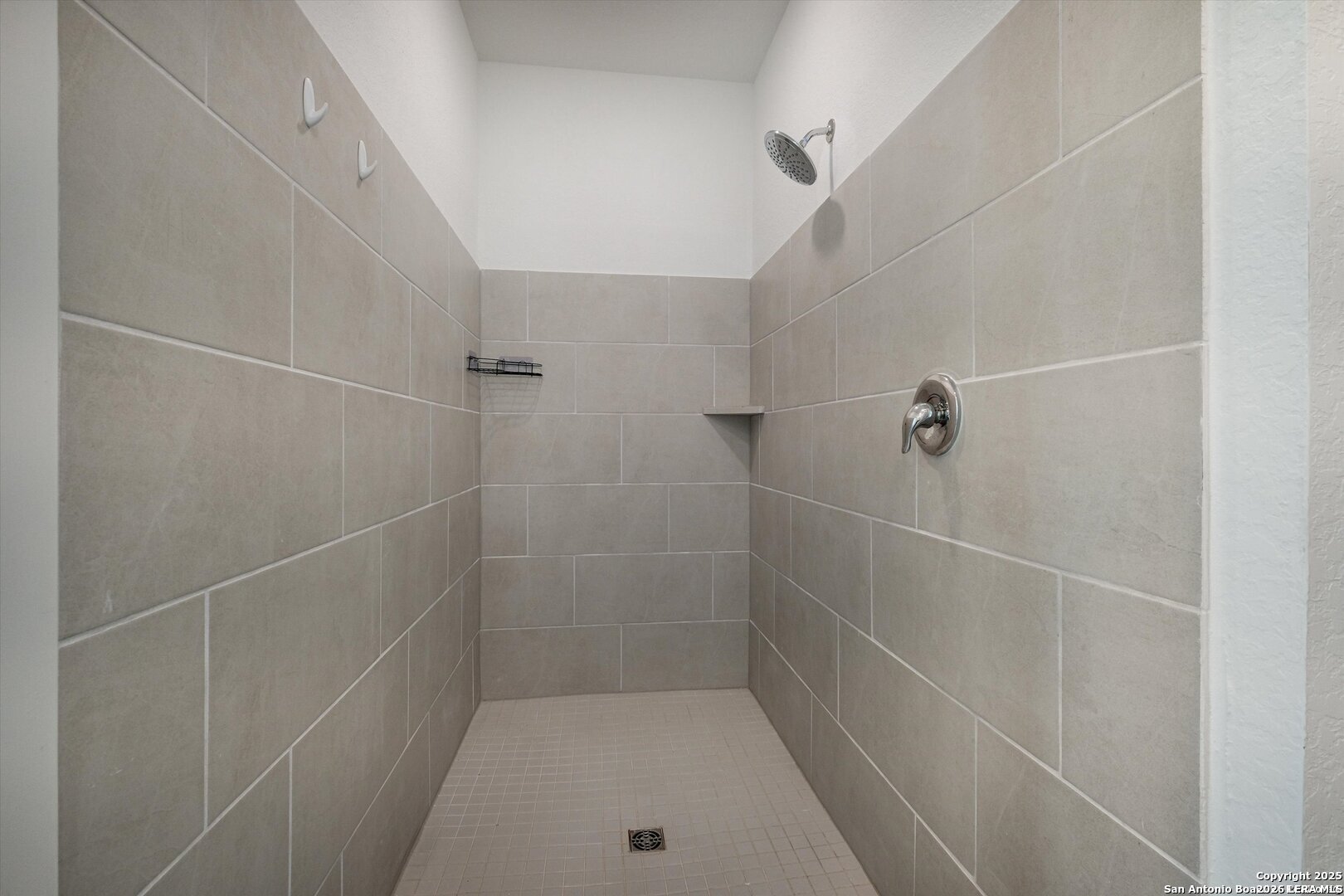 14919 Rhyolite Way Elmendorf, TX 78112 - Photo 15 of 26 a bathroom with a shower