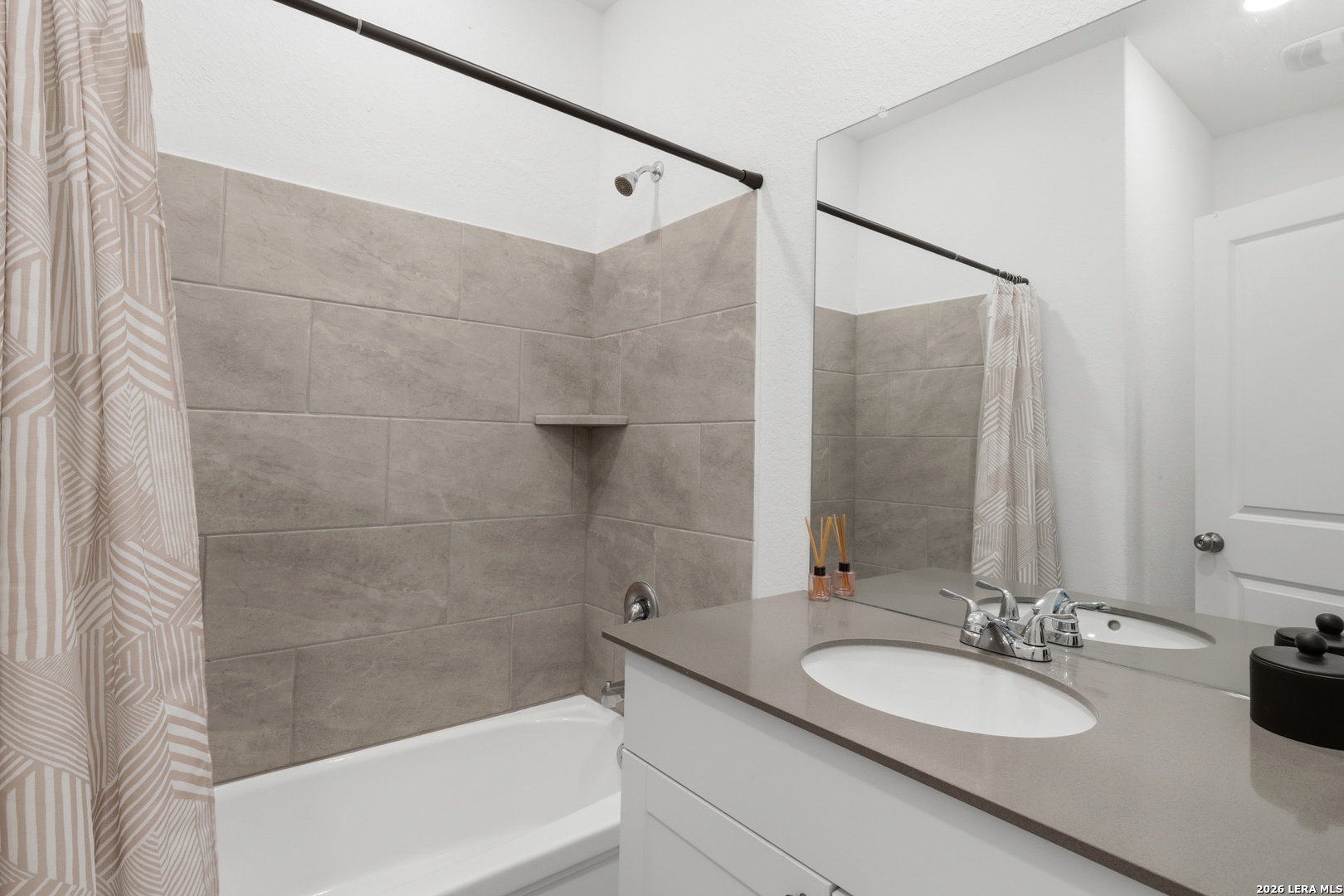 14919 Rhyolite Way Elmendorf, TX 78112 - Photo 17 of 26 a bathroom with a sink and a mirror