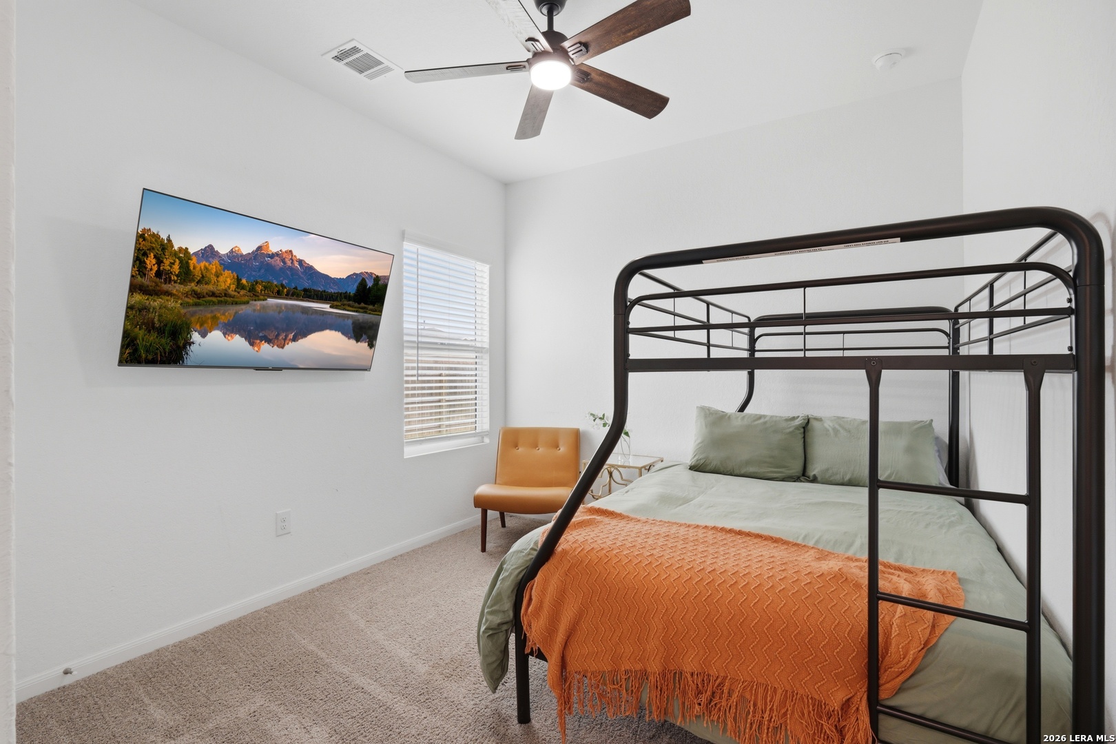 14919 Rhyolite Way Elmendorf, TX 78112 - Photo 18 of 26 a bedroom with a bed and a painting on the wall
