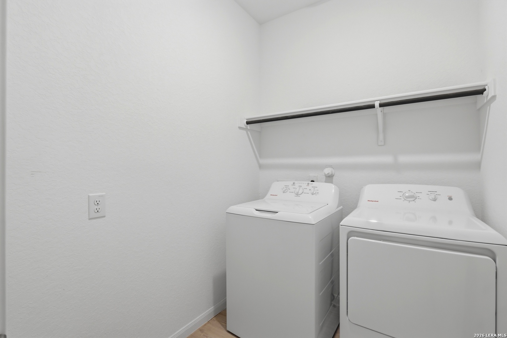 14919 Rhyolite Way Elmendorf, TX 78112 - Photo 19 of 26 a utility room with dryer and washer