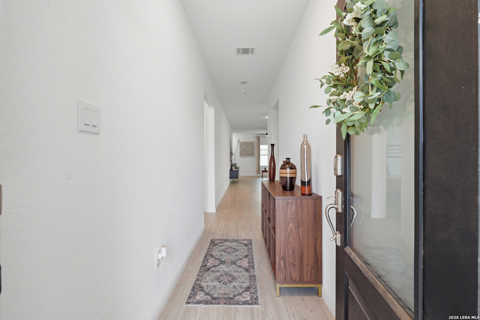 14919 Rhyolite Way Elmendorf, TX 78112 - Photo 3 of 26 a view of a hallway with a potted plant