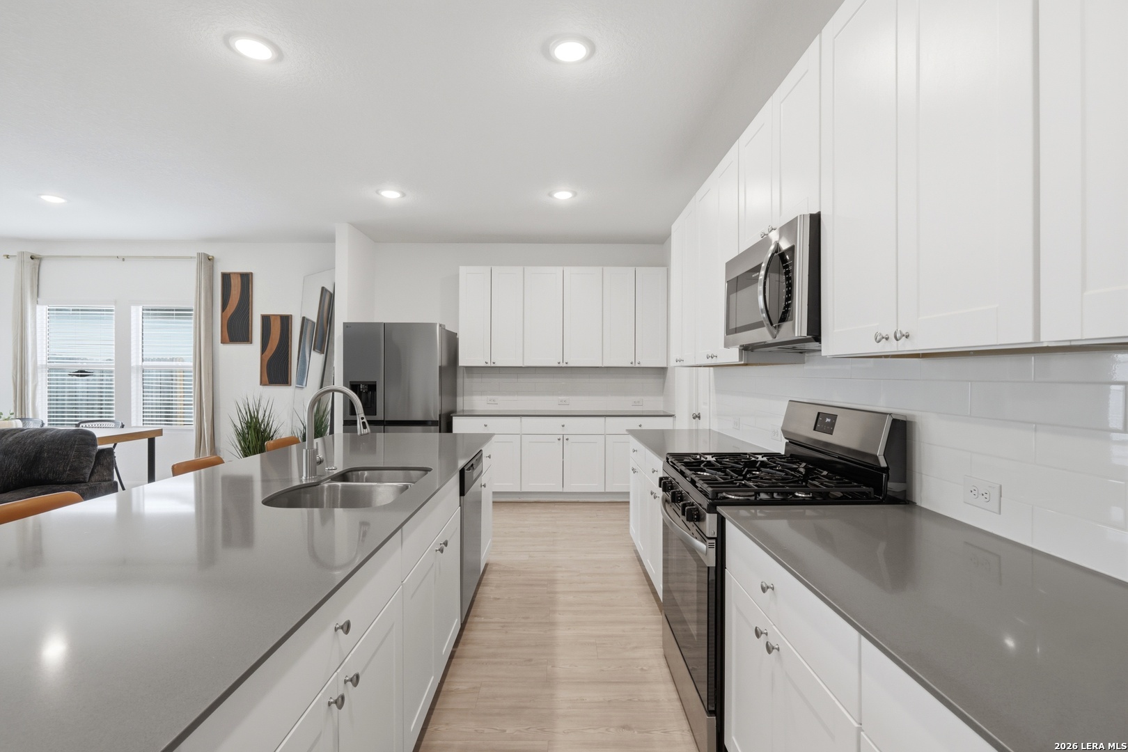 14919 Rhyolite Way Elmendorf, TX 78112 - Photo 6 of 26 a kitchen with stainless steel appliances granite countertop a sink stove and refrigerator