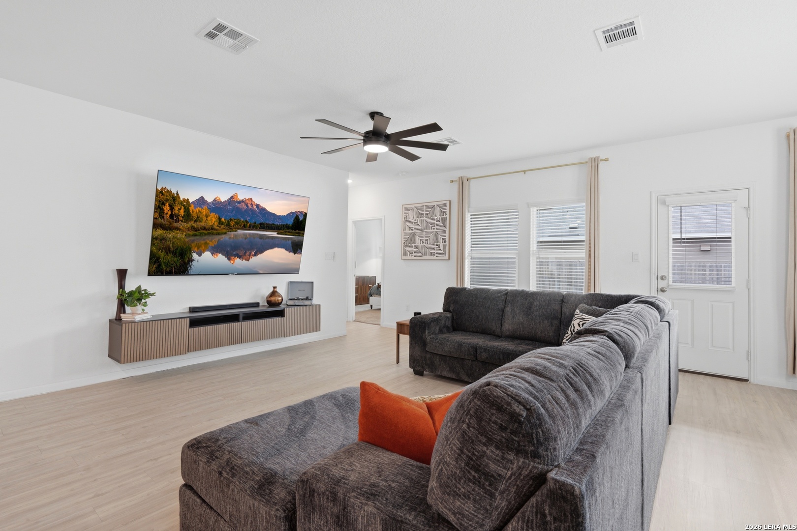 14919 Rhyolite Way Elmendorf, TX 78112 - Photo 10 of 26 a living room with furniture and a flat screen tv