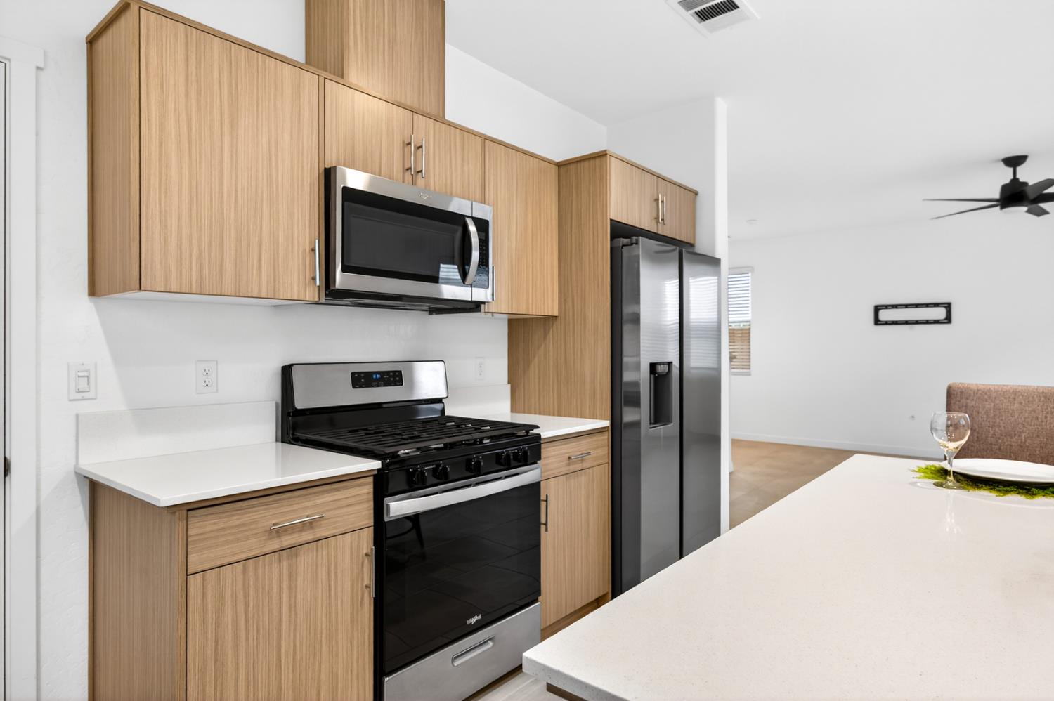 317 Talus Way South Madera, CA 93636 - Photo 12 of 61 a kitchen with stainless steel appliances a refrigerator stove and microwave
