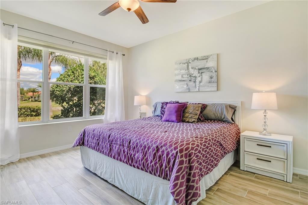 Master Bedroom with wood plank tile with King bed and lake view