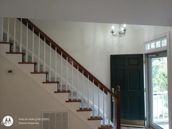 a view of entryway and hall with wooden floor