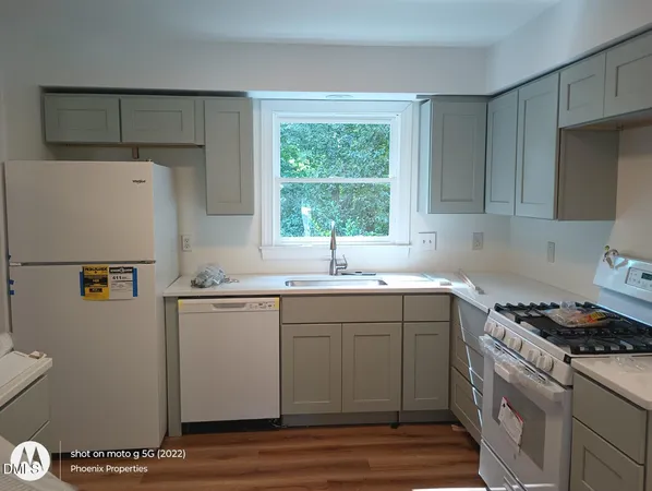 a kitchen with a sink cabinets and window