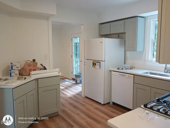 a room with a refrigerator and a sink