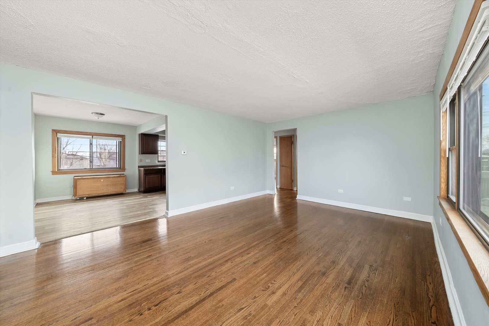 5701 West 55th Street, Unit 1S Chicago, IL 60638 - Photo 11 of 18 an empty room with wooden floor and windows