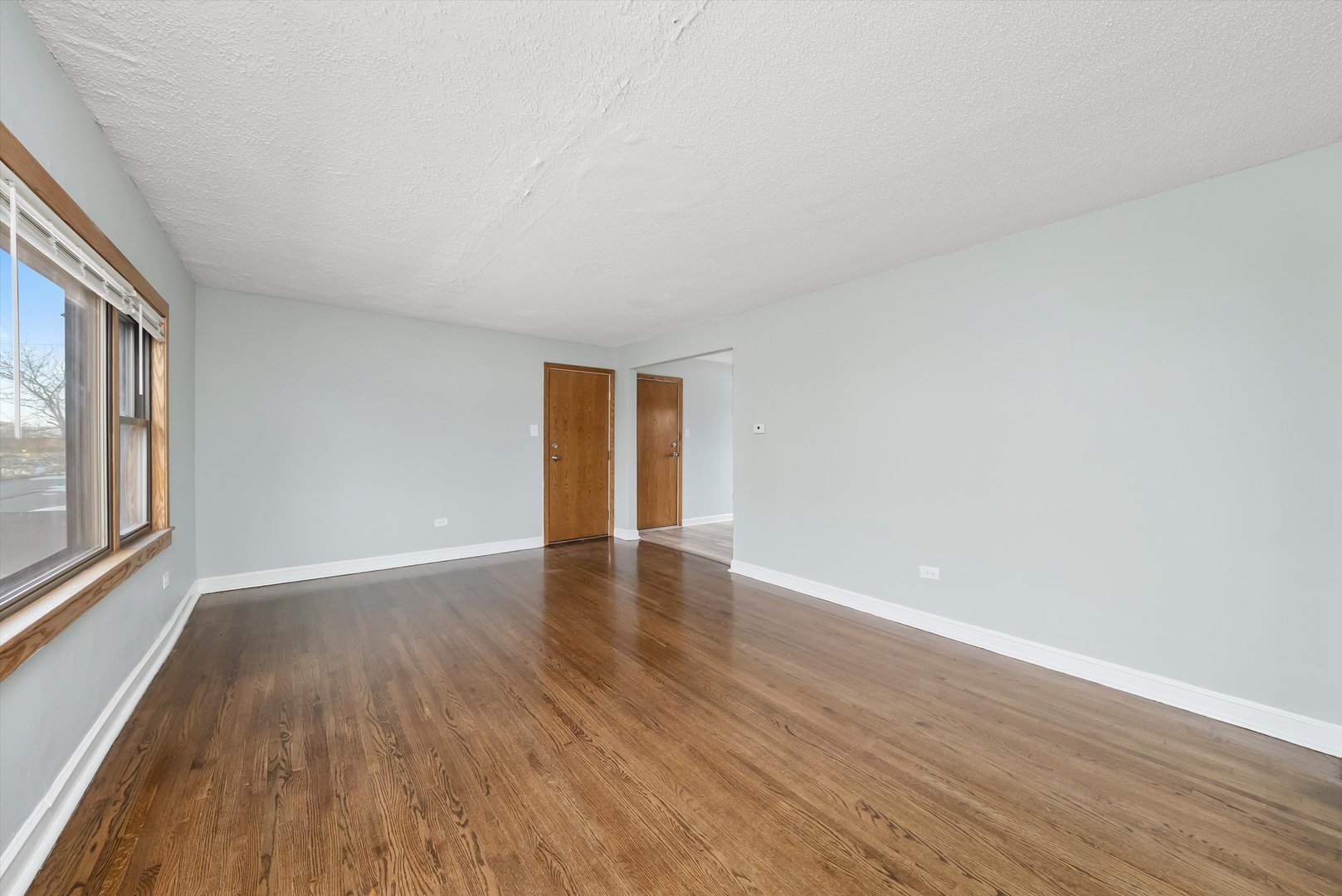 5701 West 55th Street, Unit 1S Chicago, IL 60638 - Photo 12 of 18 a view of an empty room with wooden floor and a window