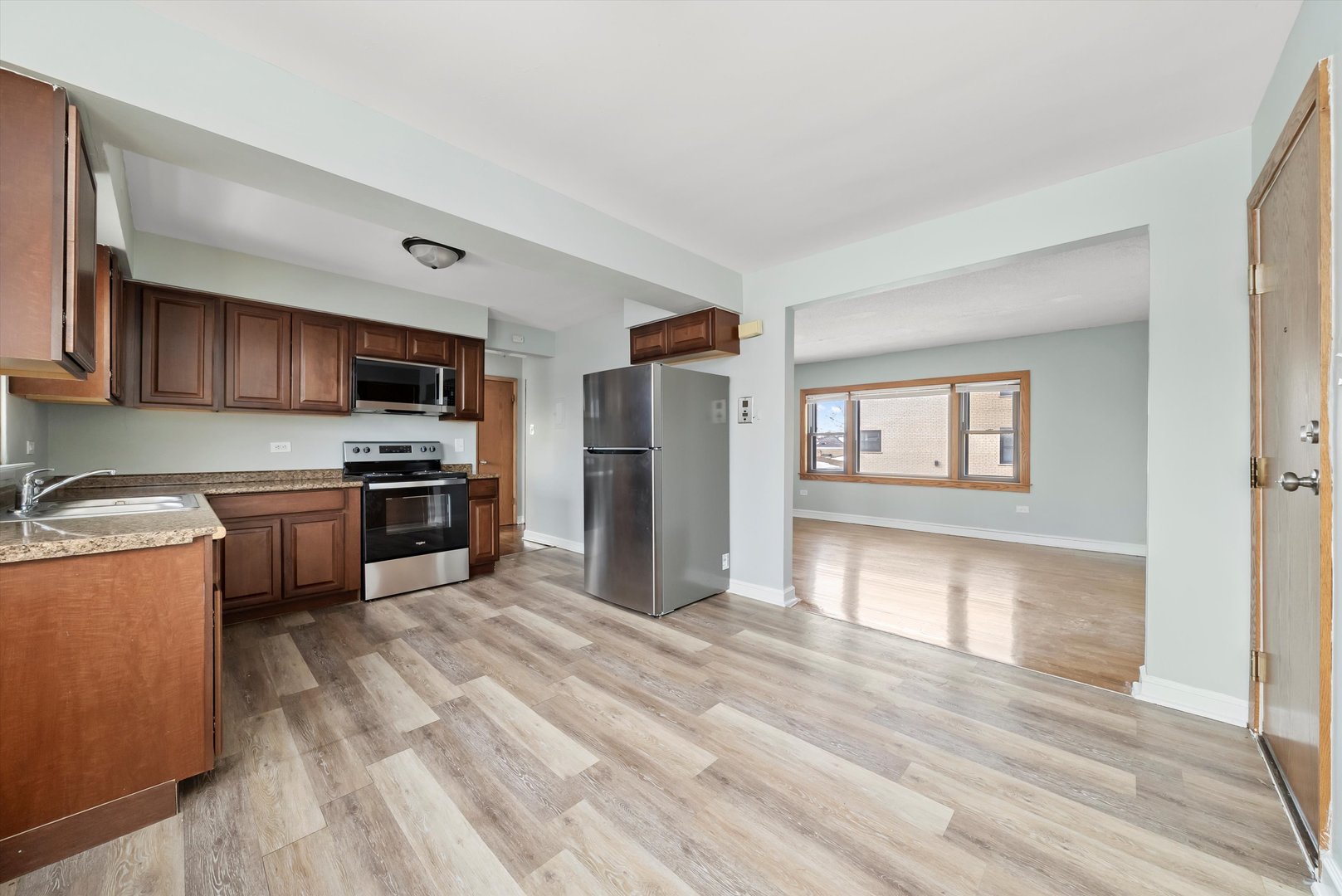 5701 West 55th Street, Unit 1S Chicago, IL 60638 - Photo 3 of 18 a kitchen with stove cabinets and refrigerator