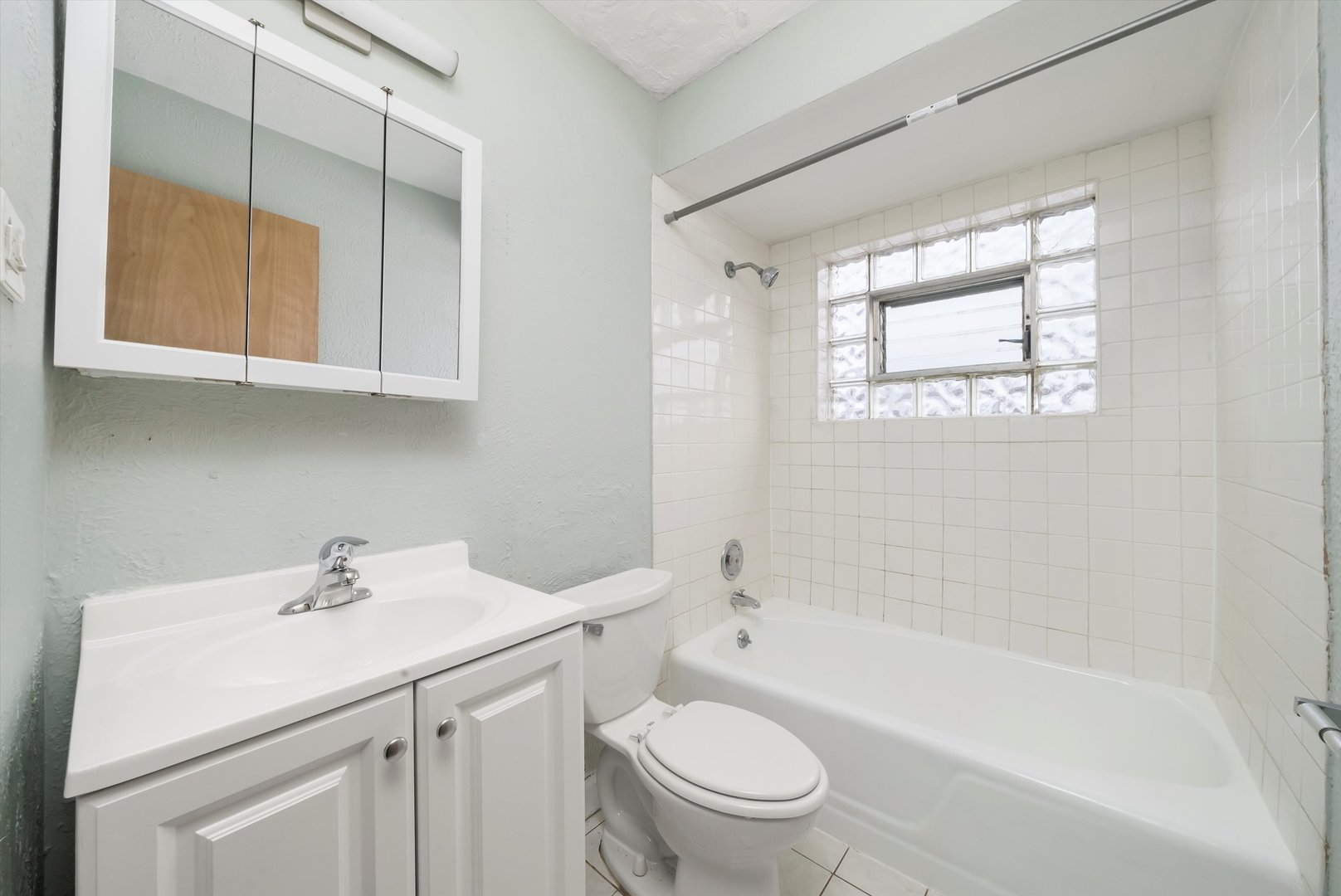 5701 West 55th Street, Unit 1S Chicago, IL 60638 - Photo 7 of 18 a bathroom with a sink a toilet and shower