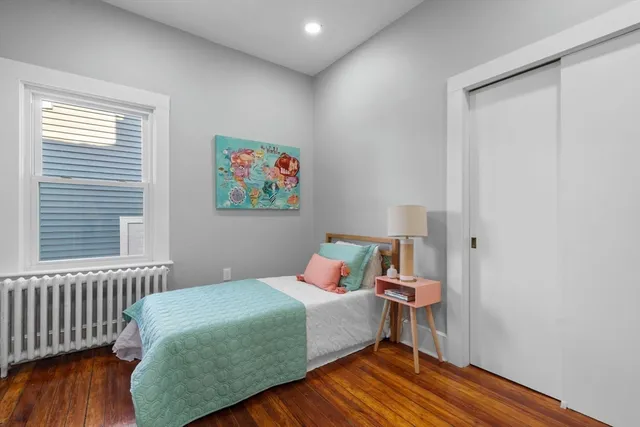 a bedroom with a bed and a dresser