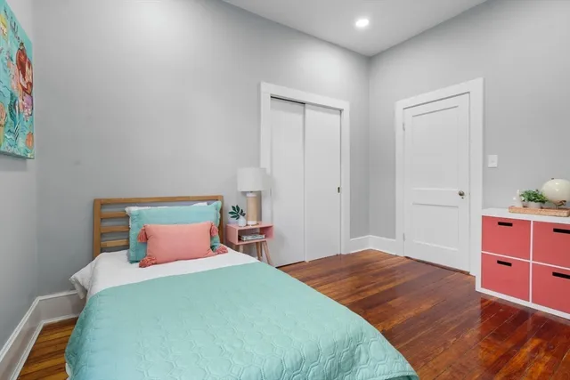 a bedroom with a bed and a tv