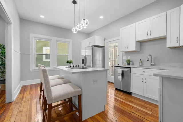 a kitchen with white cabinets and white appliances