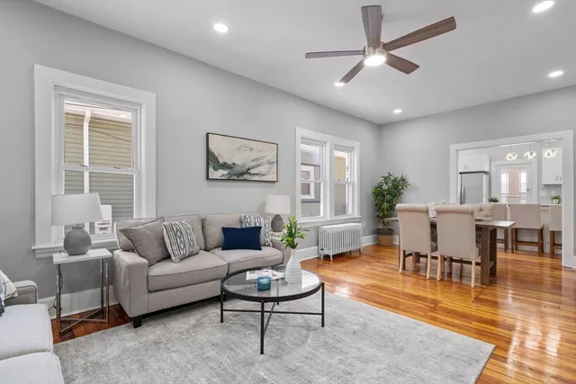 a living room with furniture a rug and a chandelier