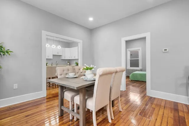 a vase of flowers sitting on a dining table