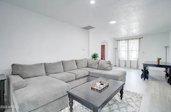 a living room with furniture rug and window