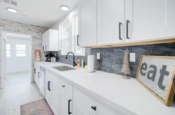 a kitchen with sink and cabinets