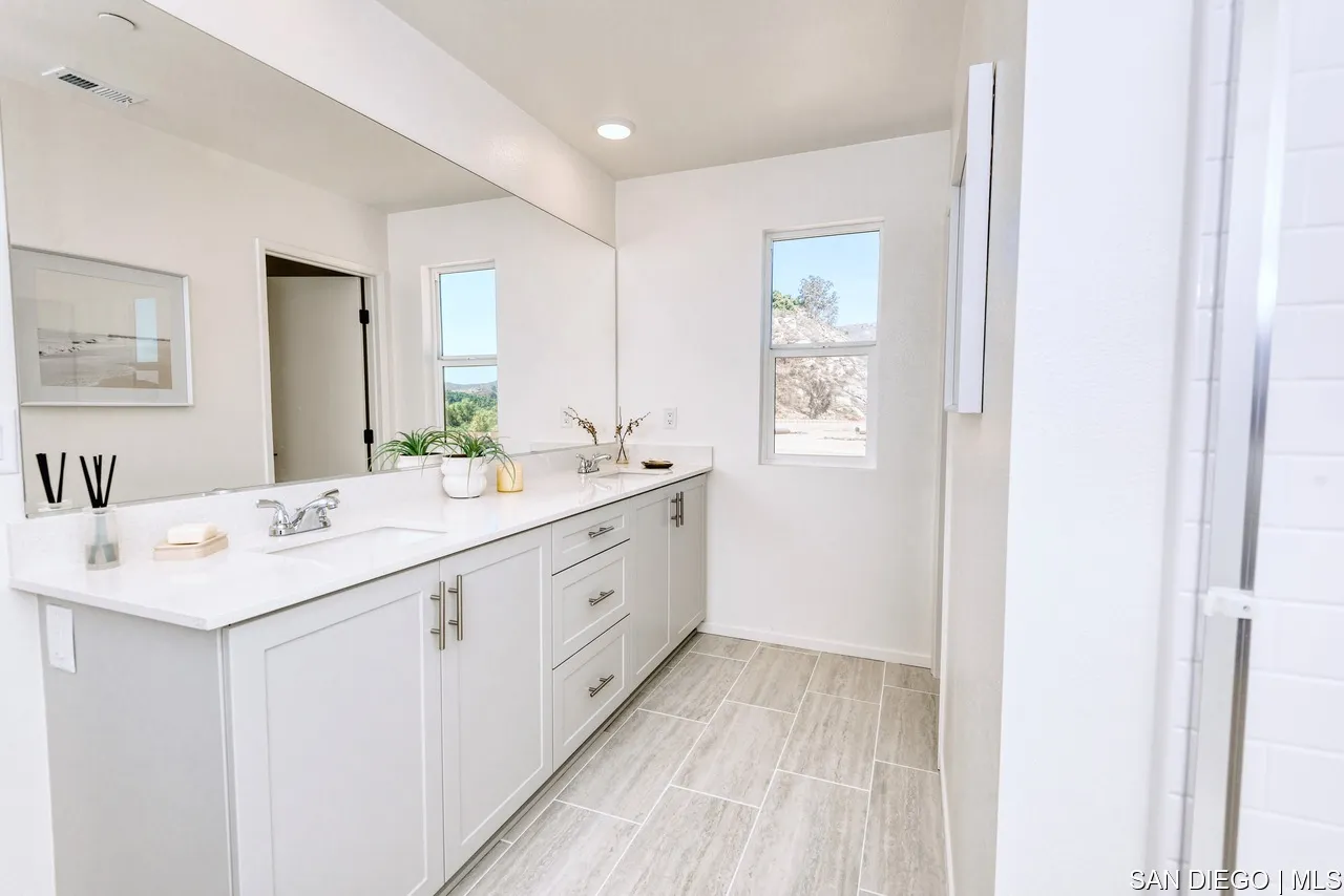 229 Paddock Lane Fallbrook, CA 92028 - Photo 19 of 33 a spacious bathroom with a double vanity sink and mirror