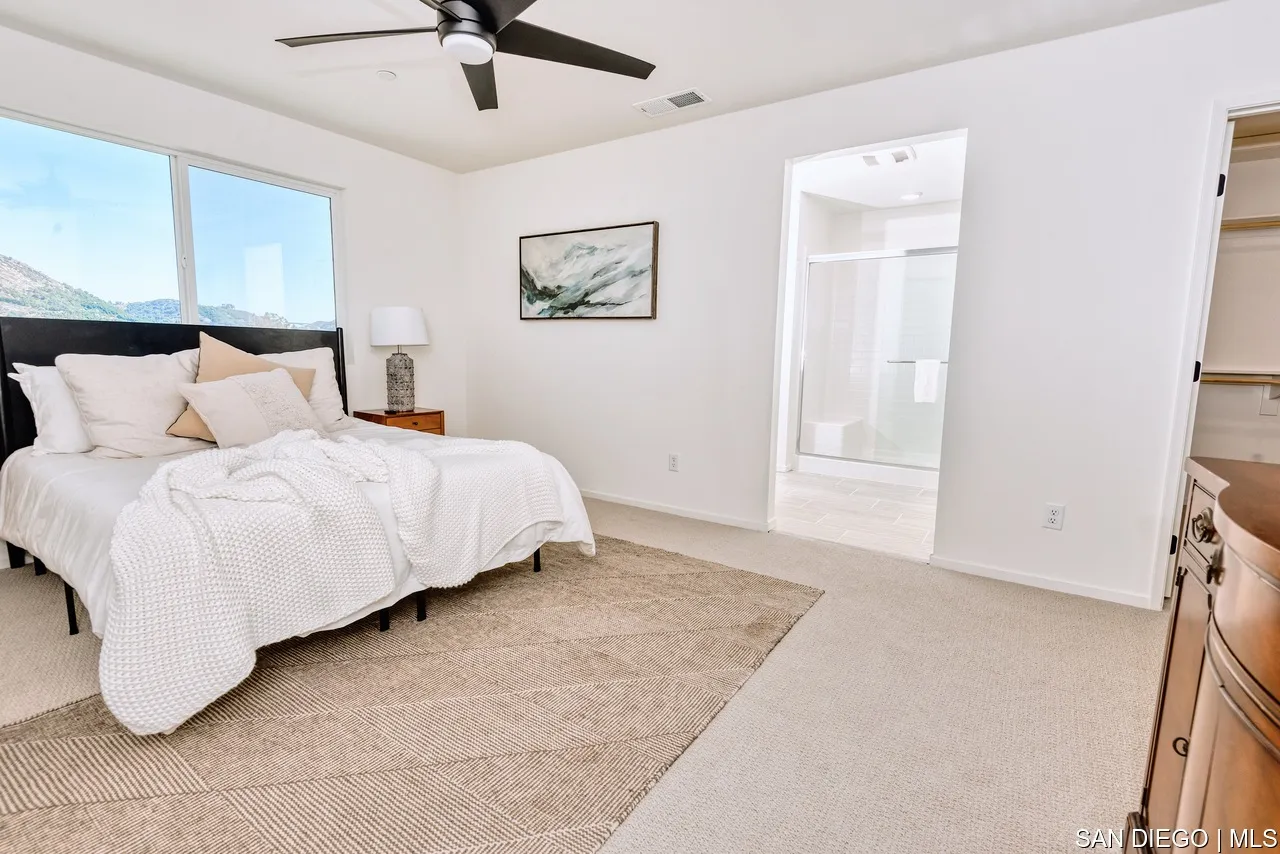 229 Paddock Lane Fallbrook, CA 92028 - Photo 20 of 33 a bedroom with a bed and painting on the wall