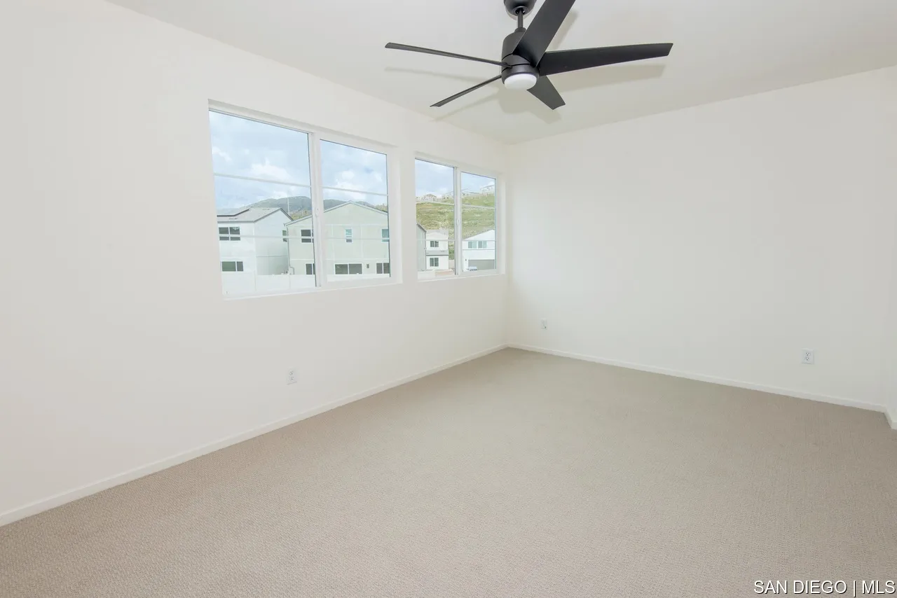 229 Paddock Lane Fallbrook, CA 92028 - Photo 22 of 33 an empty room with a window and a fan