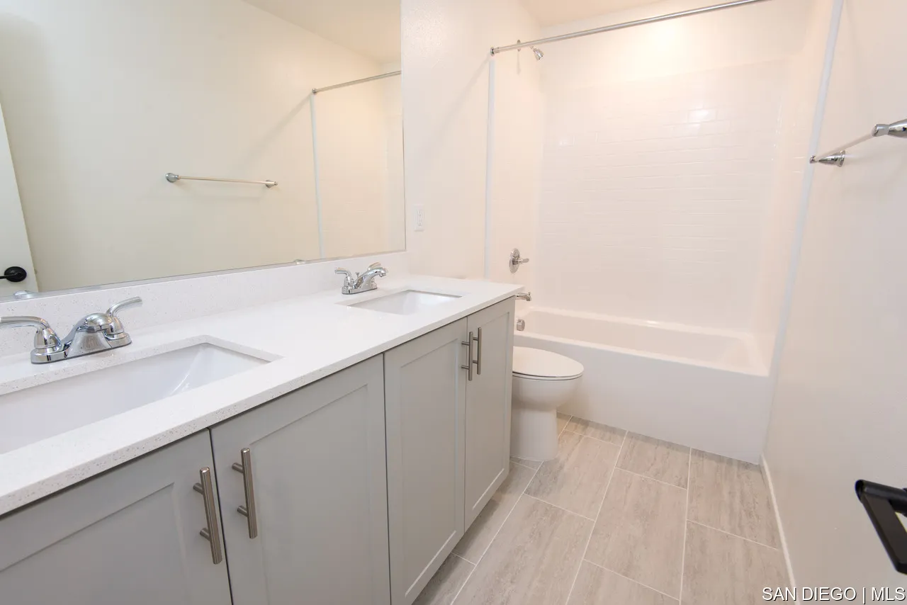229 Paddock Lane Fallbrook, CA 92028 - Photo 23 of 33 a bathroom with a granite countertop sink a toilet and a bathtub