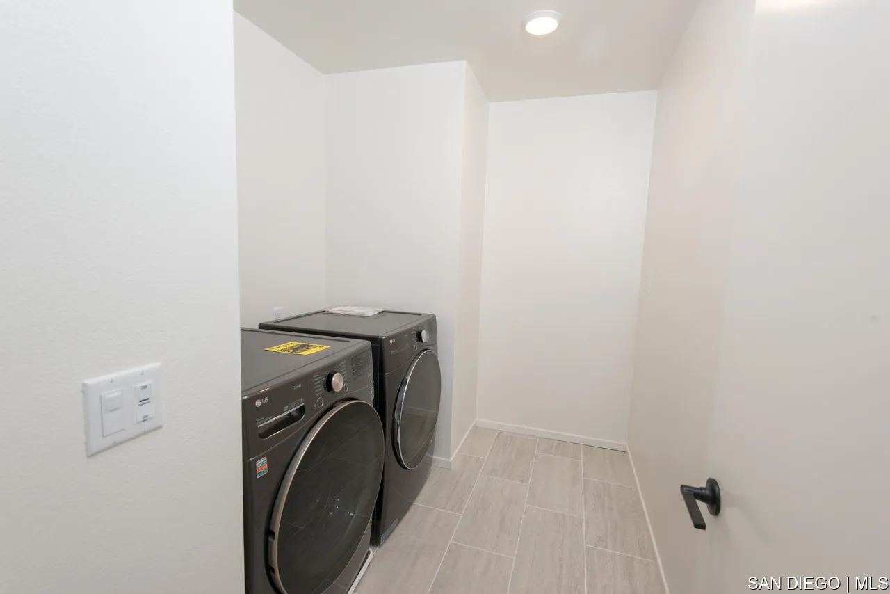 229 Paddock Lane Fallbrook, CA 92028 - Photo 27 of 33 a utility room with a sink dryer and washer