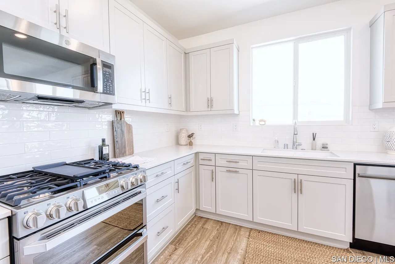 229 Paddock Lane Fallbrook, CA 92028 - Photo 4 of 33 a kitchen with stainless steel appliances granite countertop a sink stove and cabinets