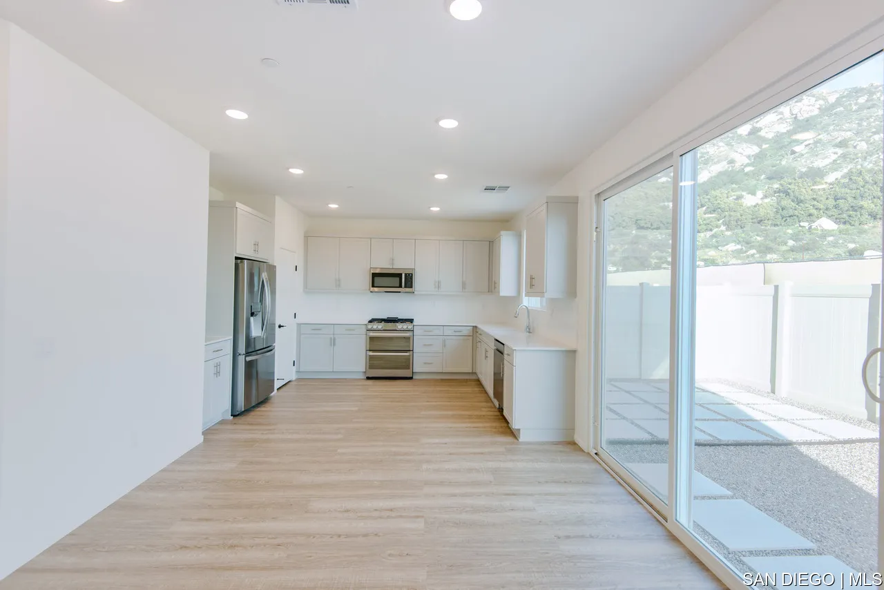 229 Paddock Lane Fallbrook, CA 92028 - Photo 8 of 33 a view of kitchen with stainless steel appliances kitchen island wooden floor and window