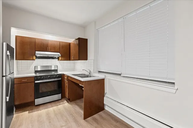 a kitchen with stainless steel appliances granite countertop a stove and a sink