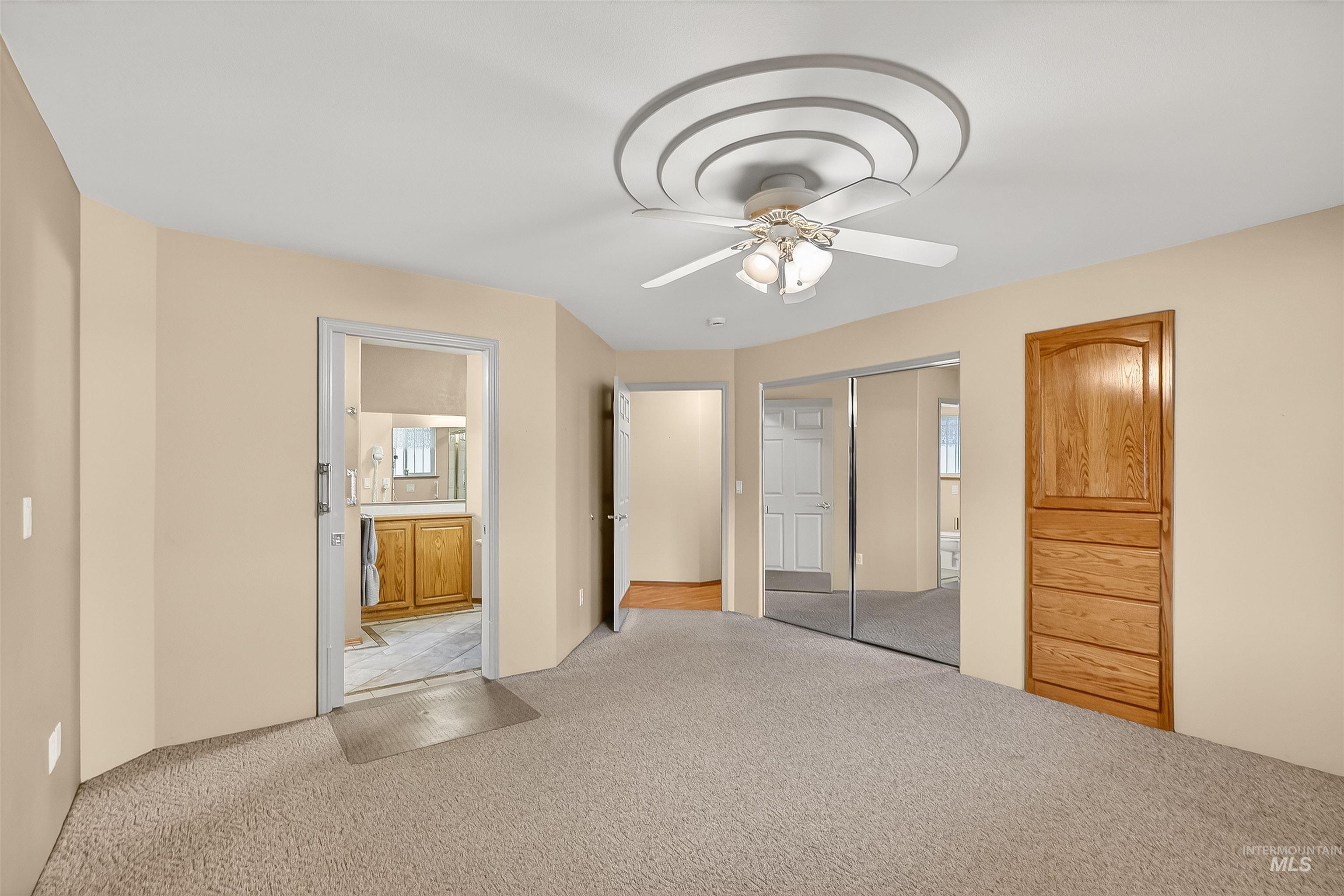 1324 Setlow Court Clarkston, WA 99403 - Photo 21 of 49 Unfurnished bedroom with carpet flooring, ensuite bathroom, a ceiling fan, and a closet